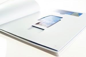 Die cut window of exhibition brochure with miniature artwork insert. 